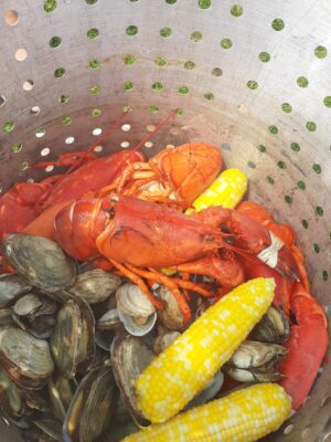 a bucket of seafood and corn